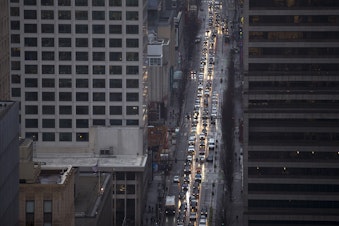 caption: FILE: Heavy traffic is shown on Friday, December 1, 2017, from Smith Tower's observation deck in Seattle. 