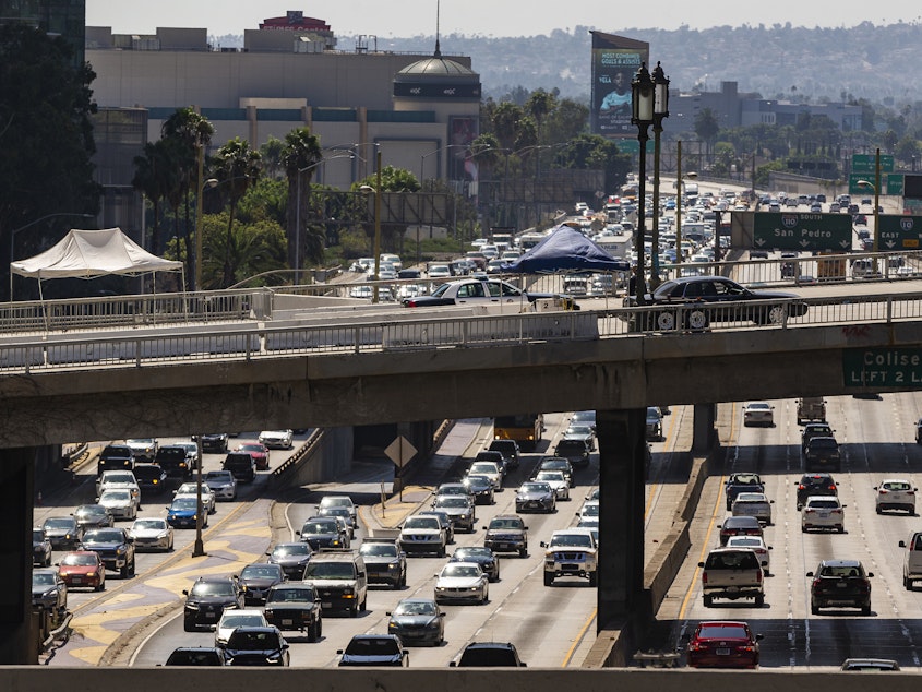 caption: A view over the Harbor Freeway in Los Angeles on Tuesday. President Trump says his administration will revoke a waiver that allows California to set its own vehicle emissions standards.