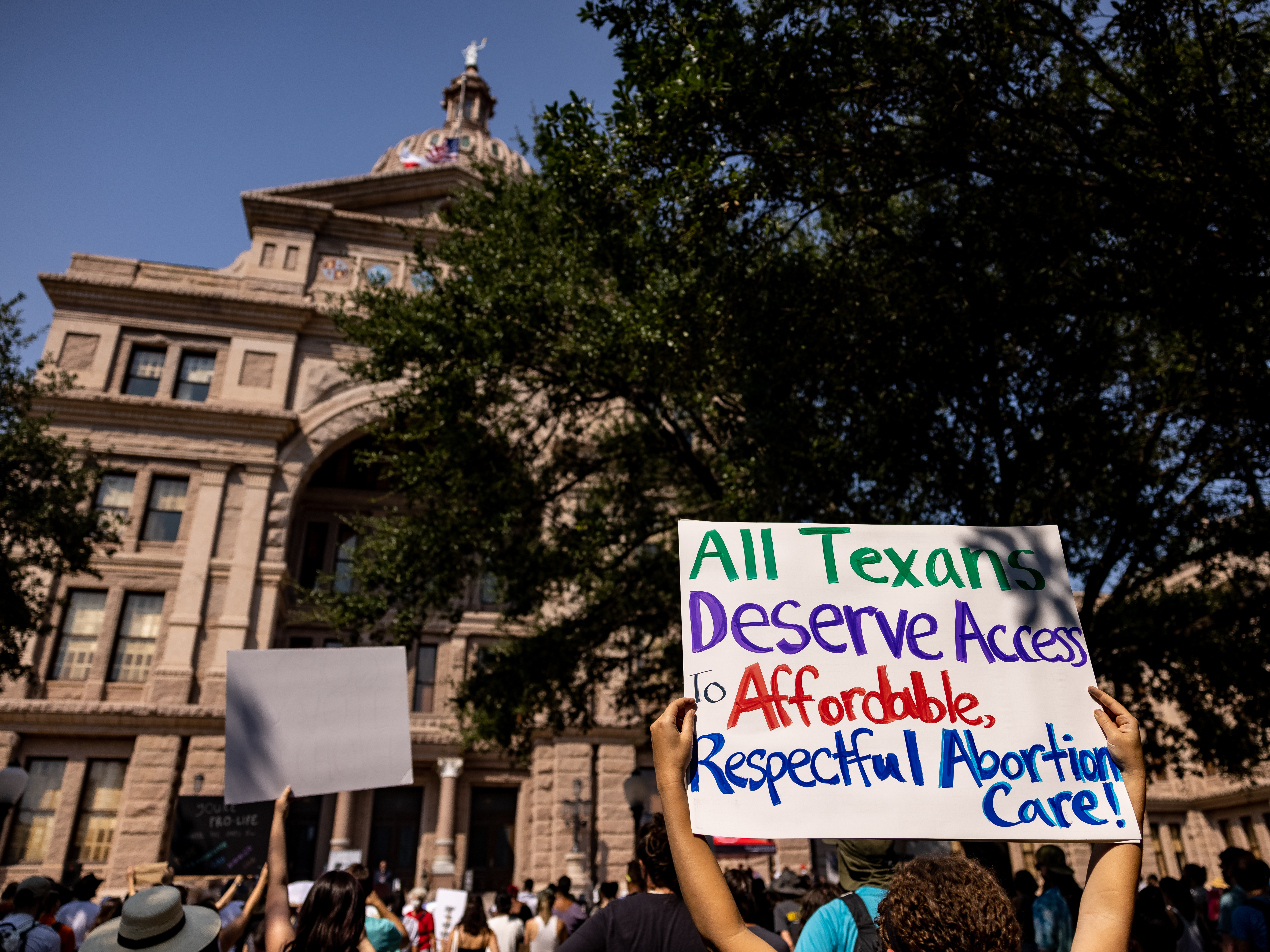 caption: Abortion rights activists rally at the Texas State Capitol on Sept. 11 in Austin in opposition to a restrictive new abortion law.