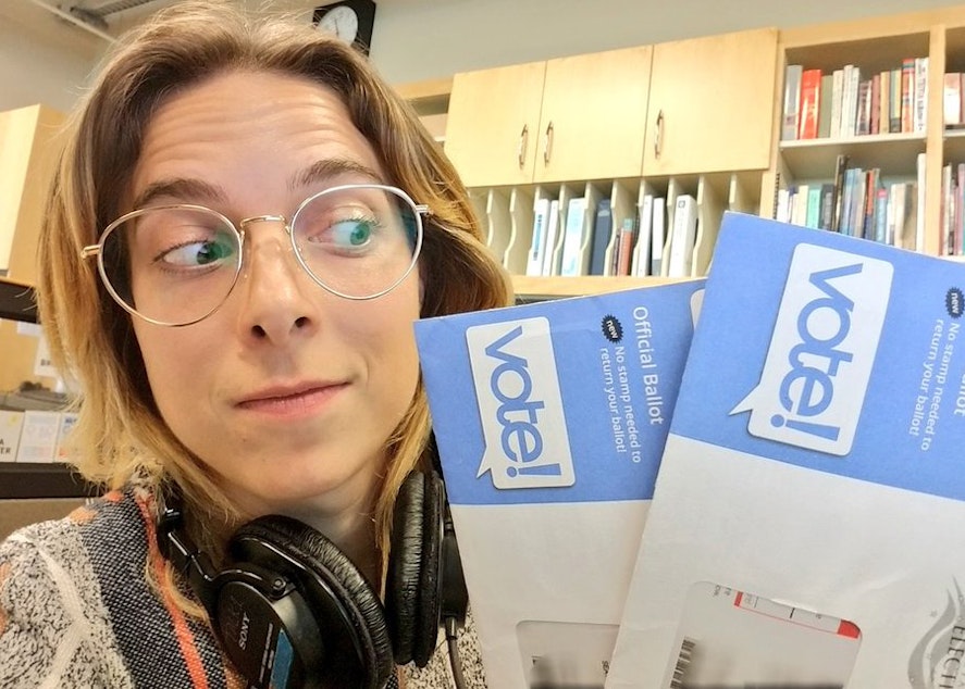 caption: KUOW newscaster Paige Browning with the two ballots she received.
