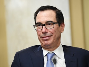 caption: Former Treasury Secretary Steven Mnuchin said he's putting together a group of investors to try to buy TikTok.