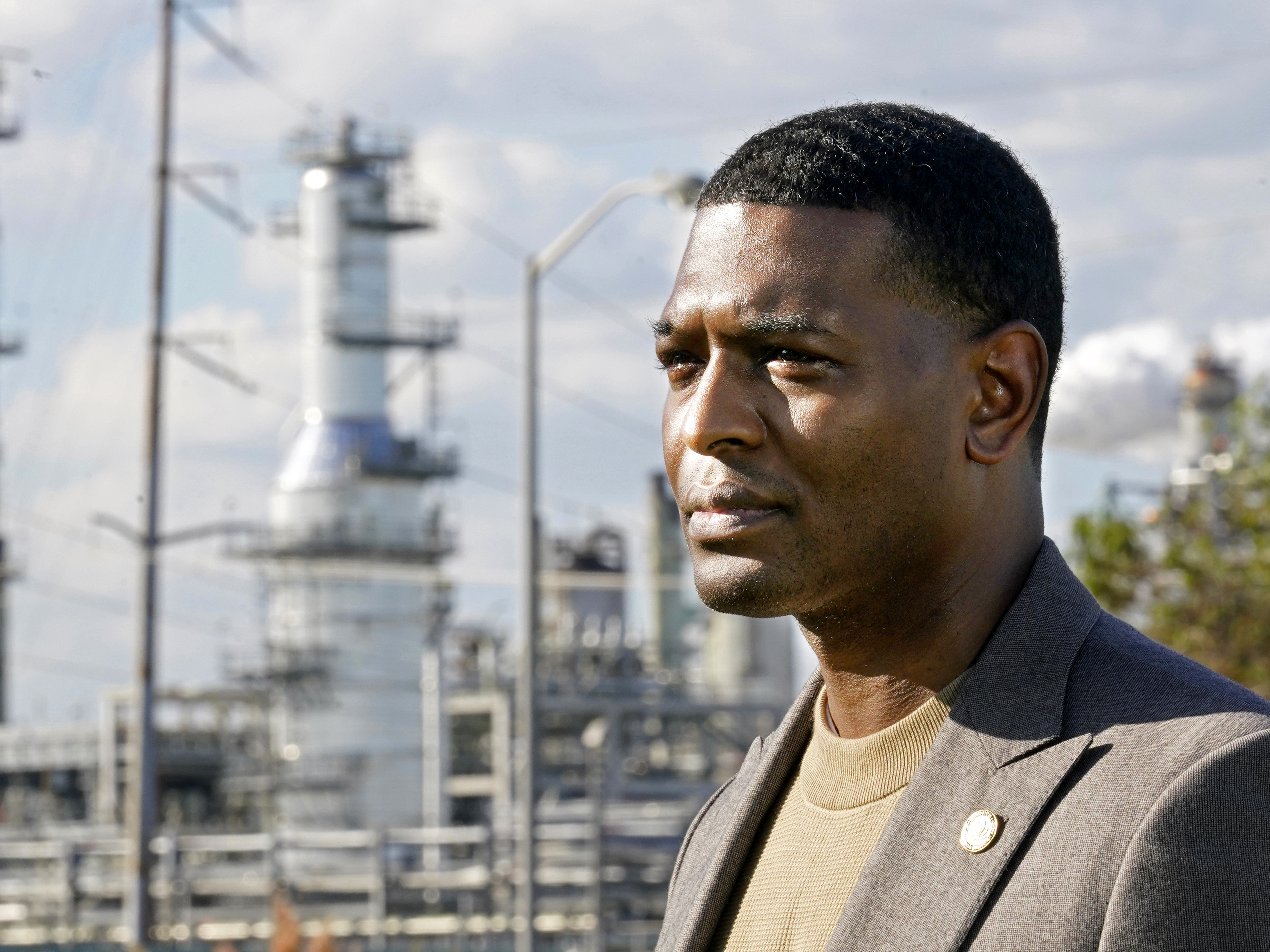 caption: EPA Administrator Michael Regan stands near the Marathon Petroleum Refinery in Reserve, La., on Nov. 16, 2021. The Environmental Protection Agency on Thursday awarded grants for projects to monitor air quality in 37 states.