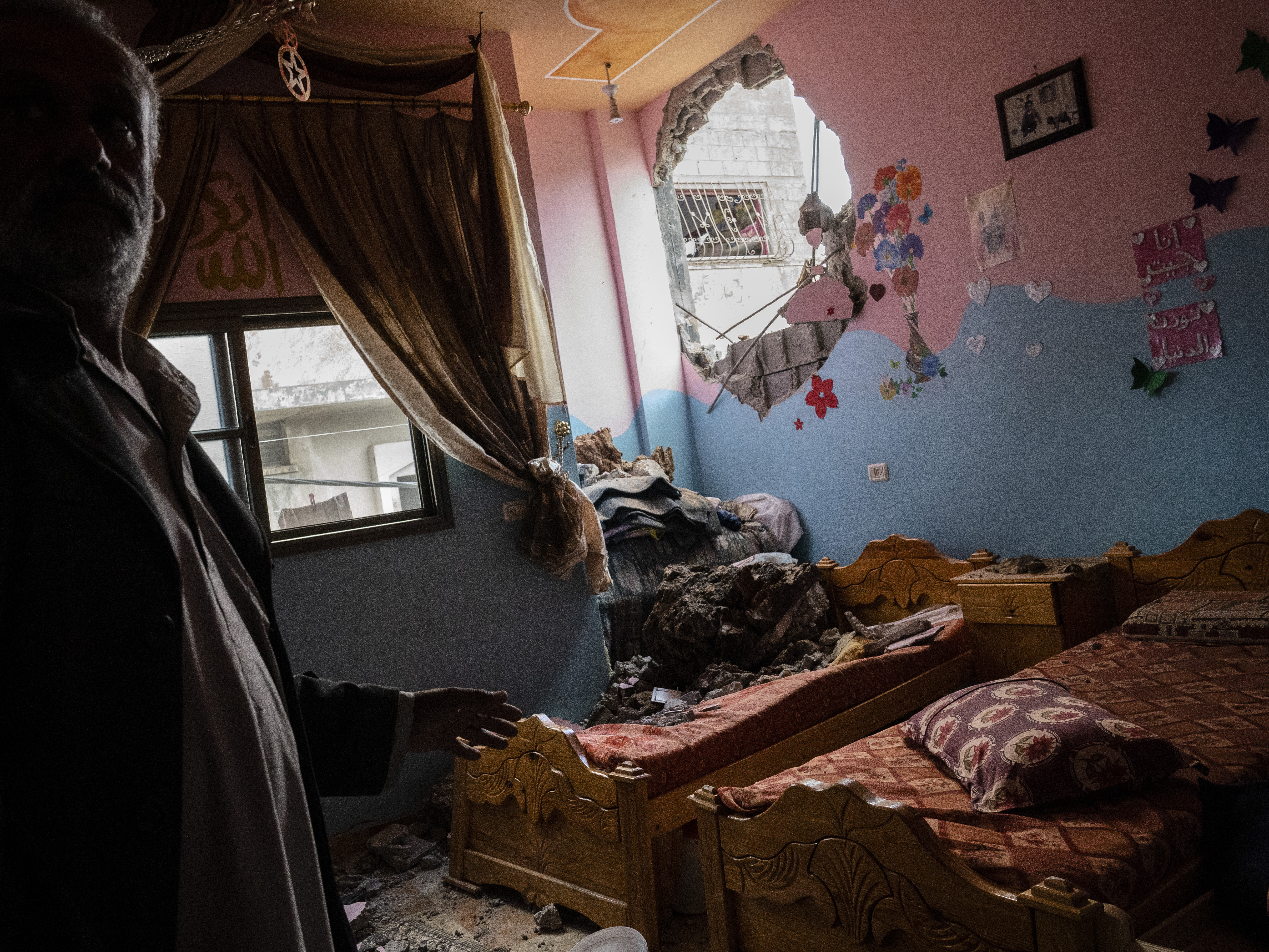 caption: A children's room in Beit Hanoun, the northern Gaza Strip, is damaged in a building destroyed by an airstrike prior to a cease-fire reached after an 11-day war between Gaza's Hamas rulers and Israel.
