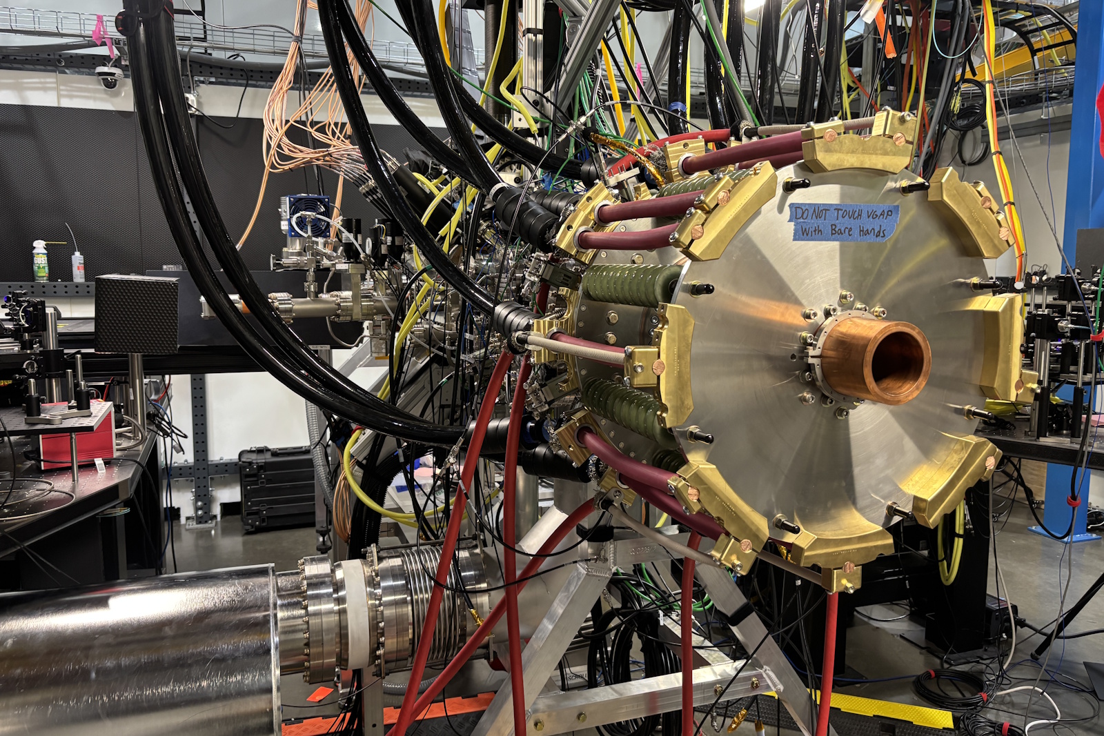 caption: One of Zap's previous reactor generations on the warehouse floor. In practice, parts of the interior surfaces of these machines are pitted away by the fusion process. Much of the science revolves around making these systems durable, in order to contain costs. Zap's method involves bathing the cylinder's inside with a continuously-recycled flow of molten metal, like an inside-out chocolate fountain. 