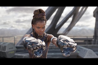 caption: Shuri readies for a fight in new Marvel film Black Panther.