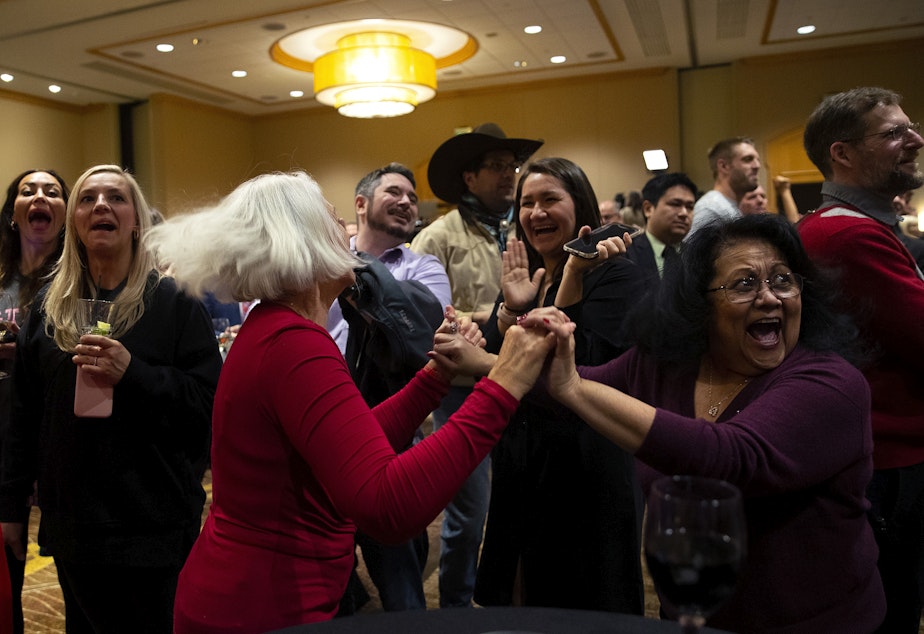 caption: Debbie Blodgett, left, and Mary Jennings, right, celebrate as election results appear on screen during a Republican Party election night gathering on Tuesday, November 8, 2022, at the Hyatt in Bellevue. 