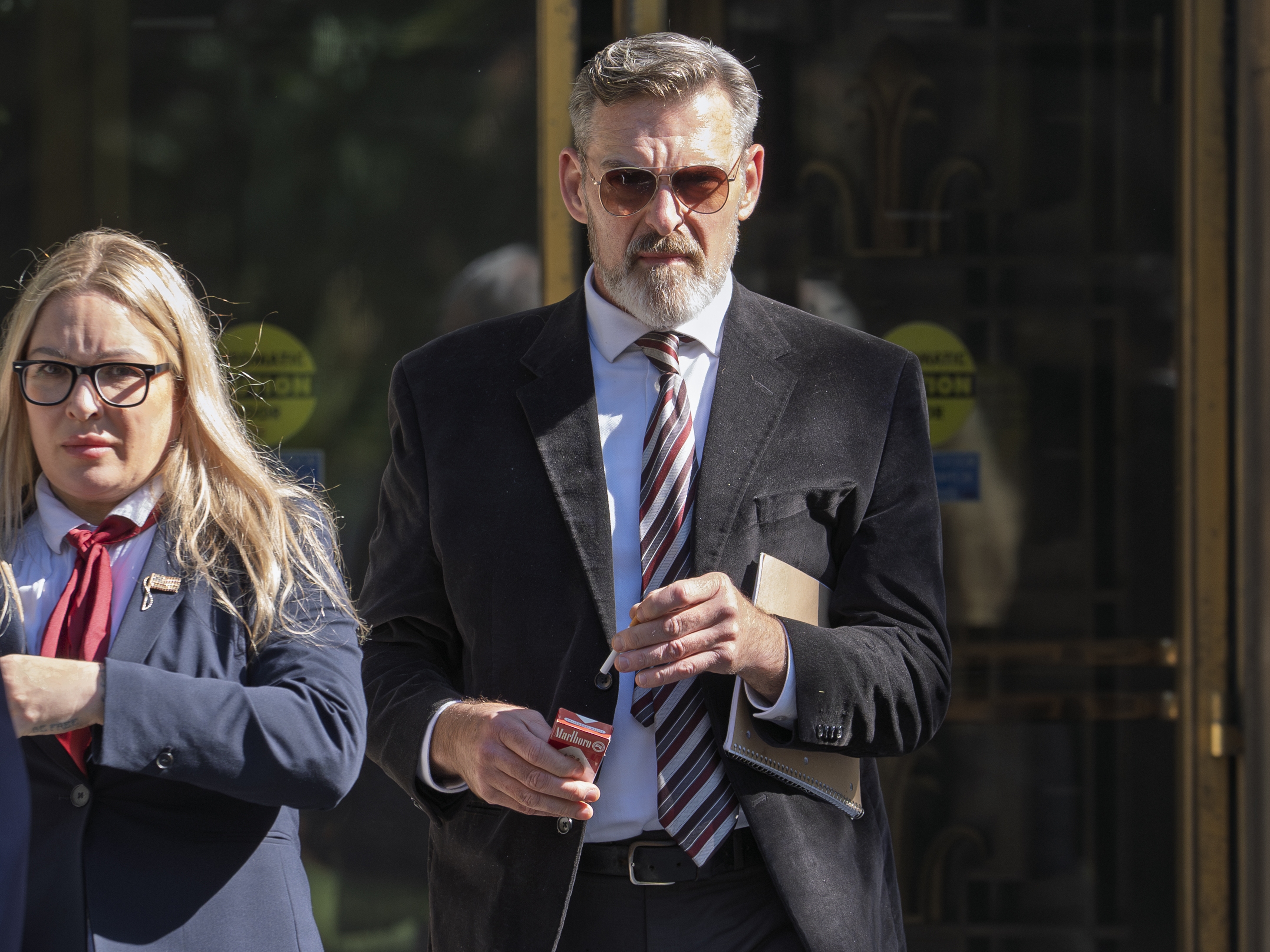 caption: Actor Jay Johnston emerges from the U.S. District Courthouse in Washington, Monday, Oct. 28, 2024, after being sentenced to one year in prison for his part in a mob’s attack on the U.S. Capitol nearly four years ago.