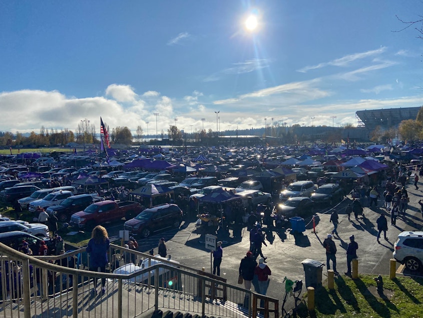 caption: UW and WSU fans tailgating outside Husky Stadium before the start of the 2023 Apple Cup.