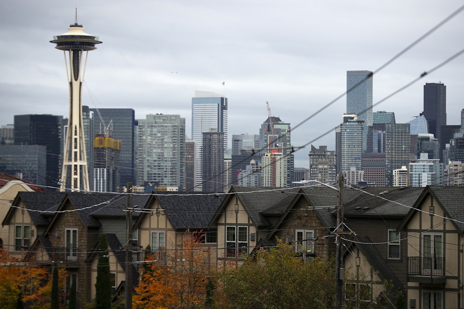 caption: Homes are shown in the foreground of downtown Seattle on Tuesday, October 16, 2024, along West Olympic Place in Queen Anne.
