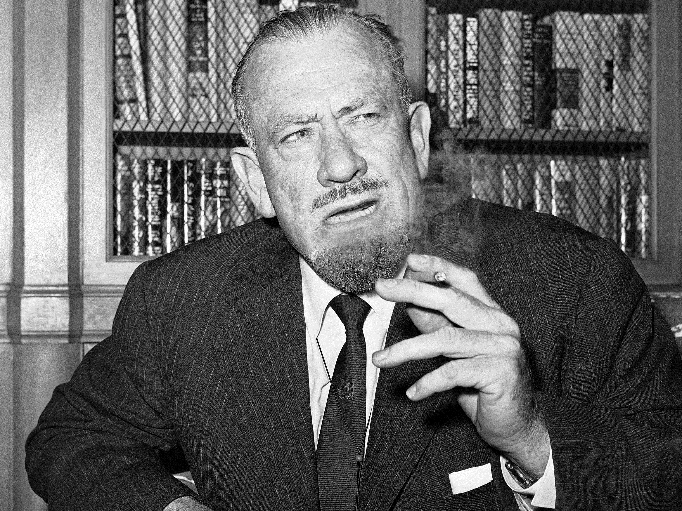 caption: John Steinbeck talks to media in the office of his publisher in New York on Oct. 25, 1962.