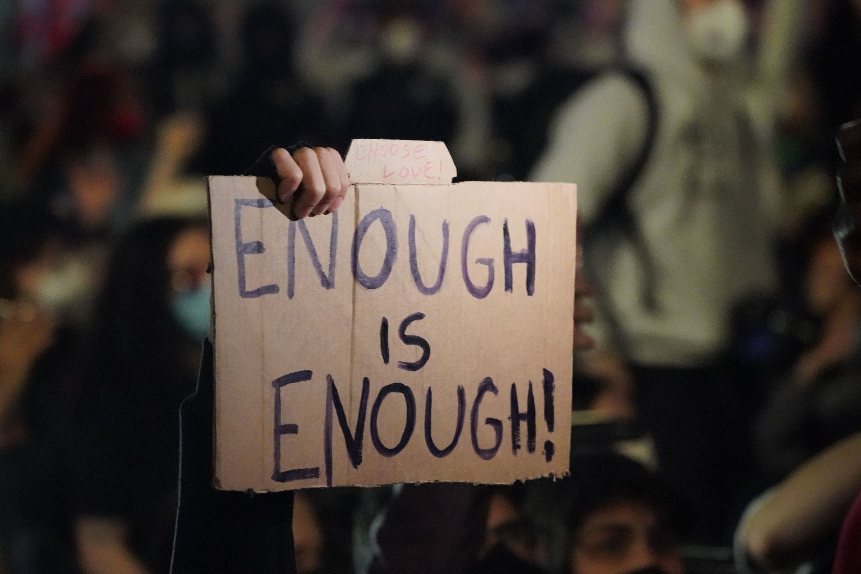 caption: A person holds up a sign as protesters kneel on Canal St. during a demonstration over the death of George Floyd in police custody in Minneapolis on May 31, 2020 in New York.(Bryan R. Smith / AFP via Getty Images)