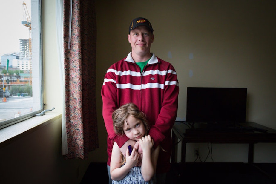 caption: Tyrus Gilbertson stands with one of his children, Corrine Gilbertson, 7, inside Mary's Place Guest Rooms.