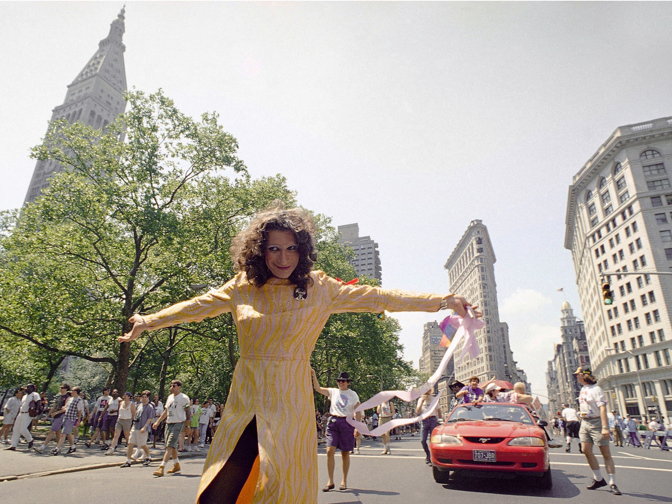 caption: Sylvia Rivera leads an ACT-UP march past New York's Union Square Park in June 1994.