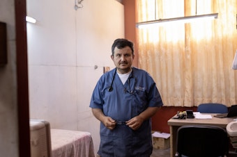 caption: Raymond Portelli, priest and doctor, in his office in the San Martin de Porres church in Iquitos, Peru. In the early days of the pandemic, he says he wasn't too worried about this new coronavirus. But his early optimism would quickly evaporate.