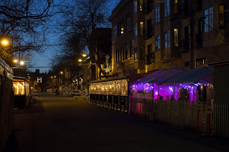 caption: People dine in outdoor dining areas set up along Ballard Avenue Northwest on Monday, March 22, 2021, in Seattle. Beginning Monday, restaurants, retailers, and fitness centers can open with up to 50% capacity as Washington's 39 counties move into the third phase of Gov. Jay Inslee's reopening plan.