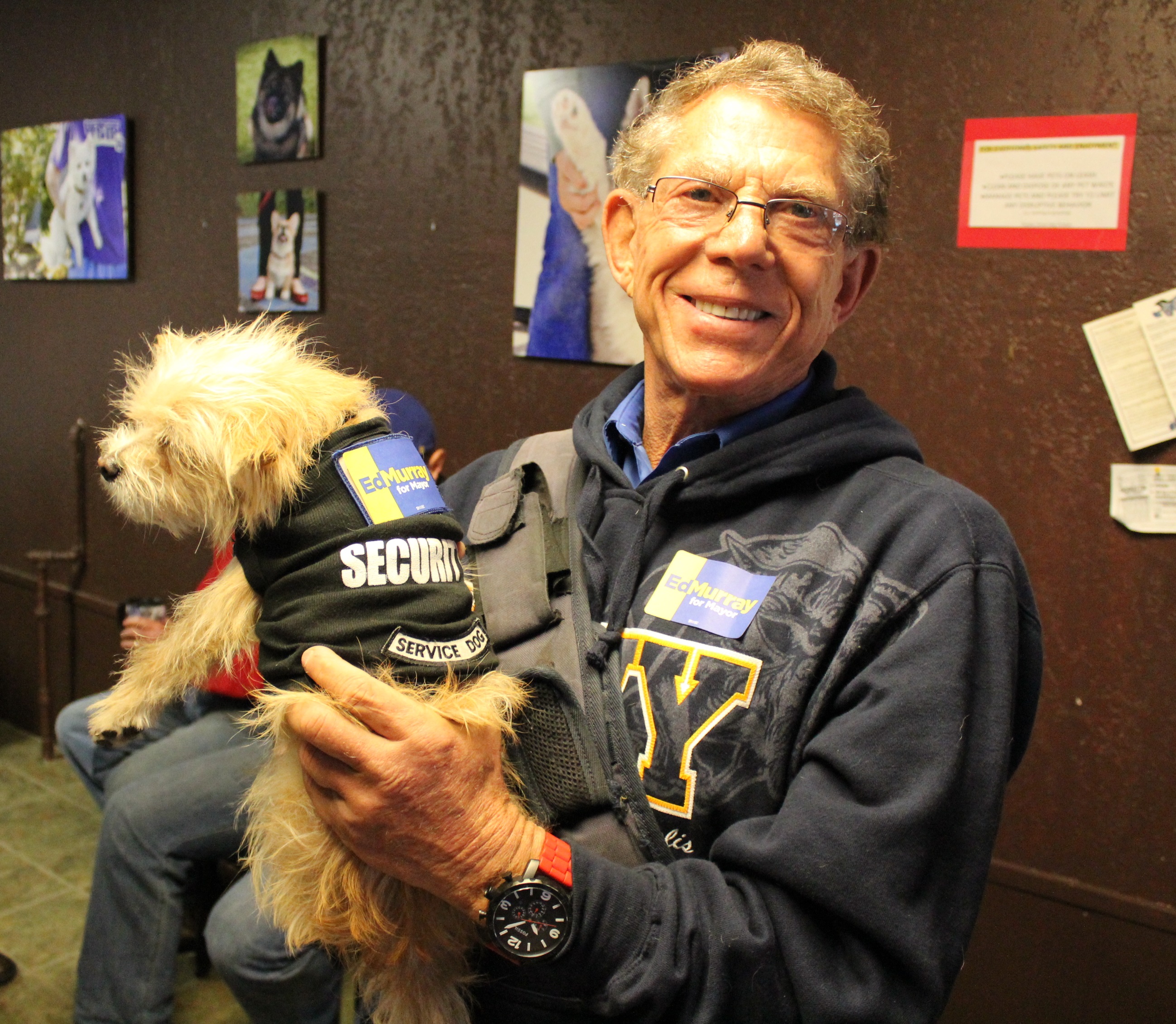 caption: Volunteer Gordon Myers and his dog, Skipper, prepare to canvas for Ed Murray 