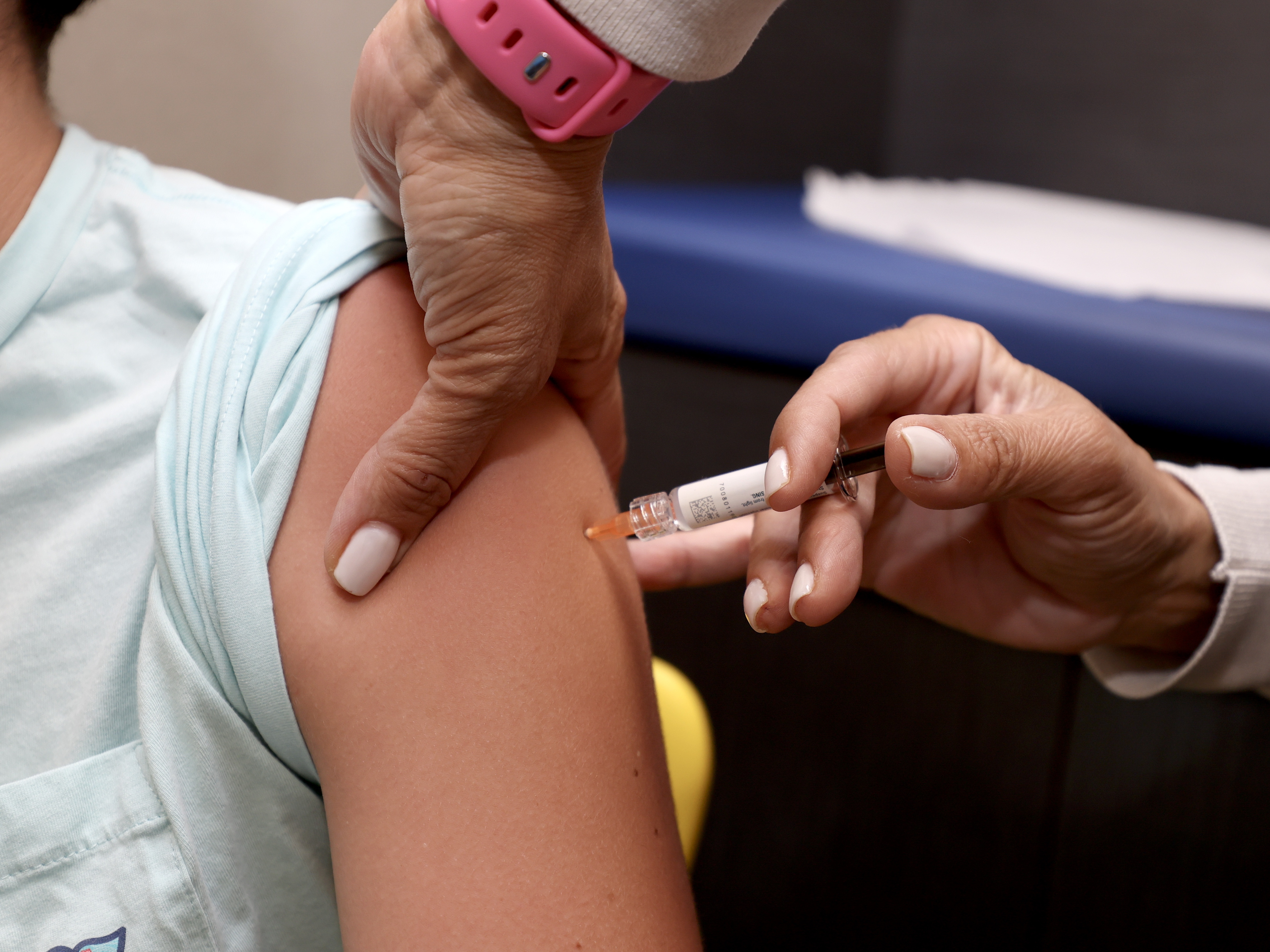 caption: A child gets immunized at a Florida pediatrician's office in September.