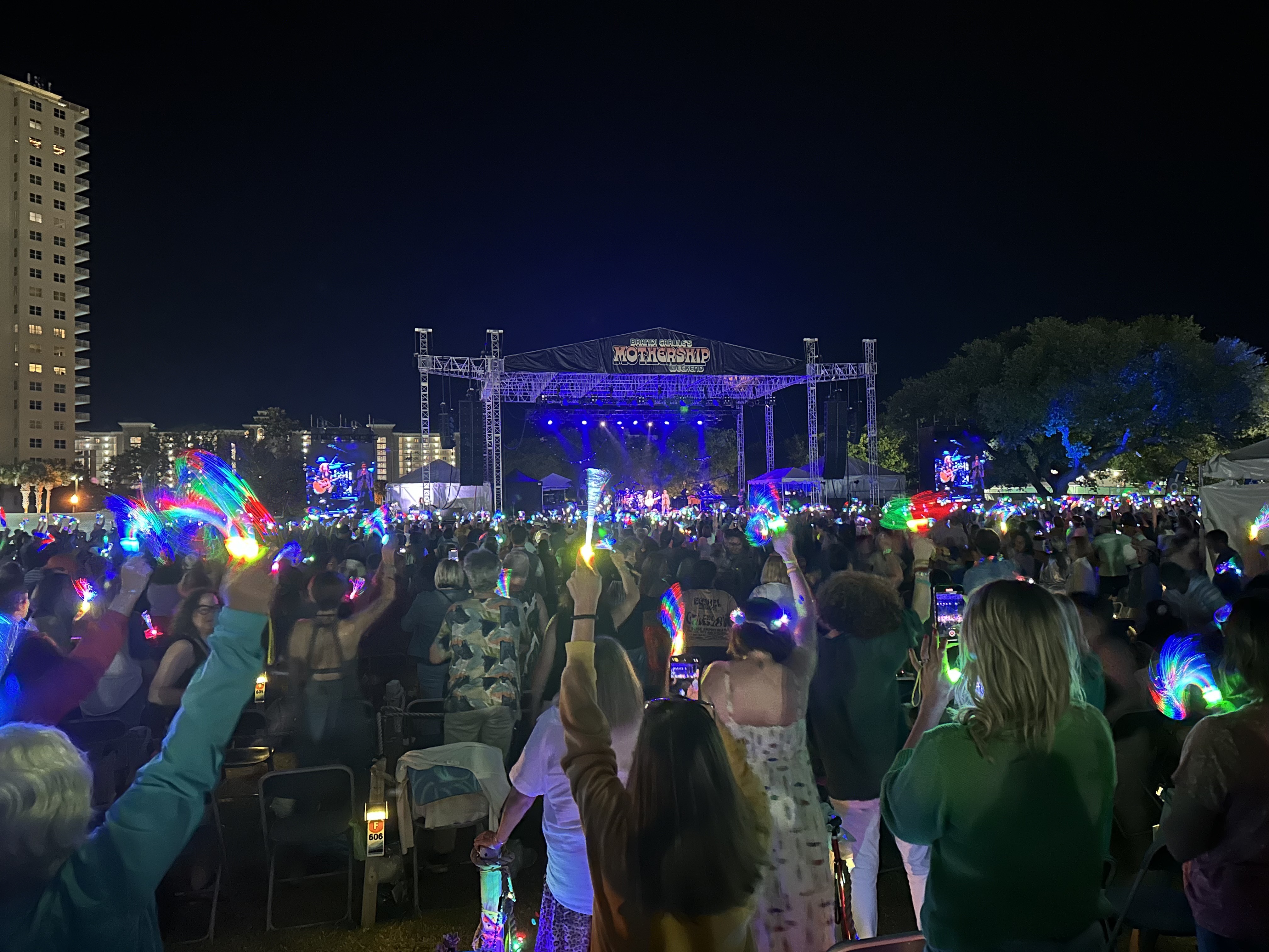 caption: Fans light up their coves at Brandi Carlile's Mothership Weekend music festival in Miramar Beach, Fla.
