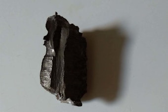 caption: A shard of shrapnel protrudes from a wall. City Hospital No. 2 has routinely operated on patients who've needed shrapnel and bullets extracted from their bodies.