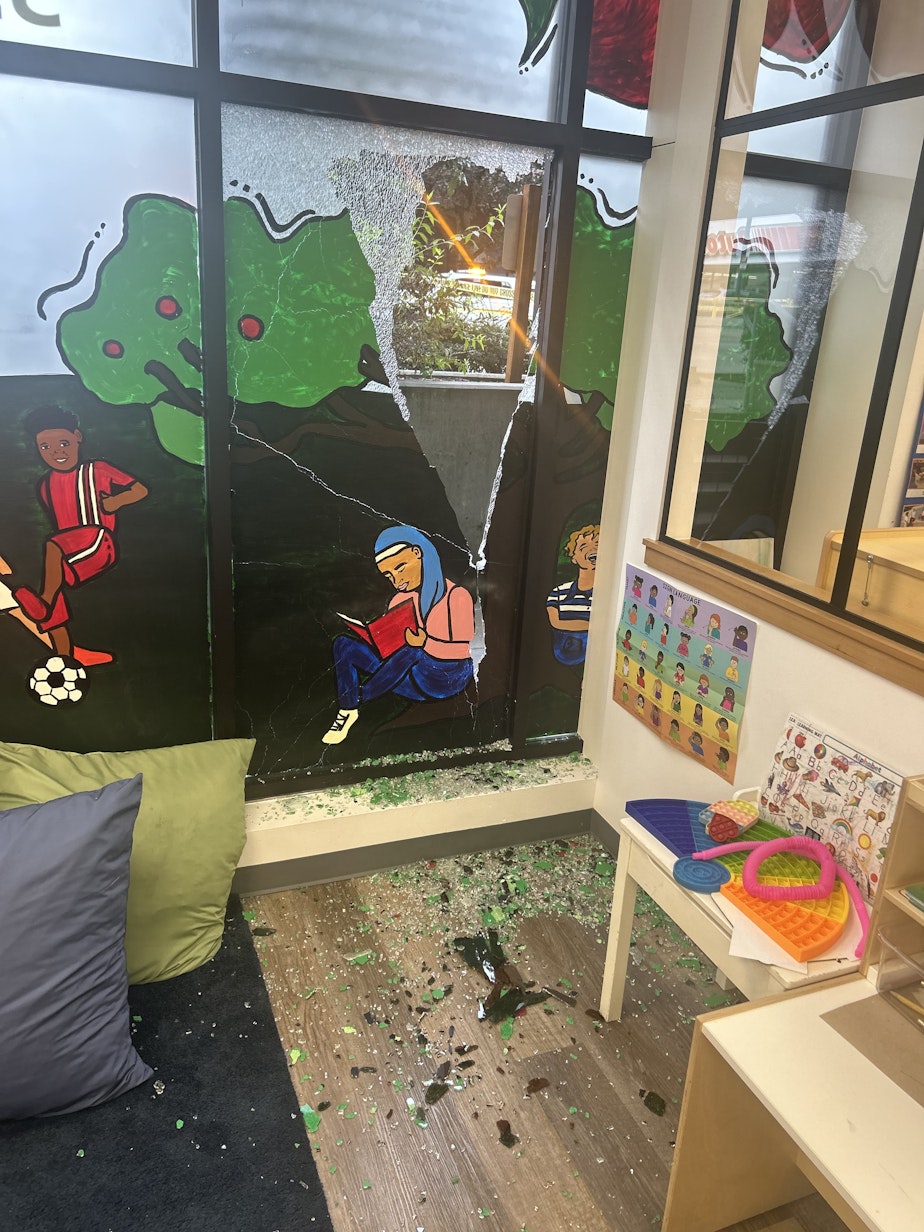 caption: A window at A 4 Apple Learning Center in Seattle's Central District was struct by a stray bullet on Oct. 16, 2023. Co-owner Appollonia Washington wants bulletproof glass to protect her students and staff.
