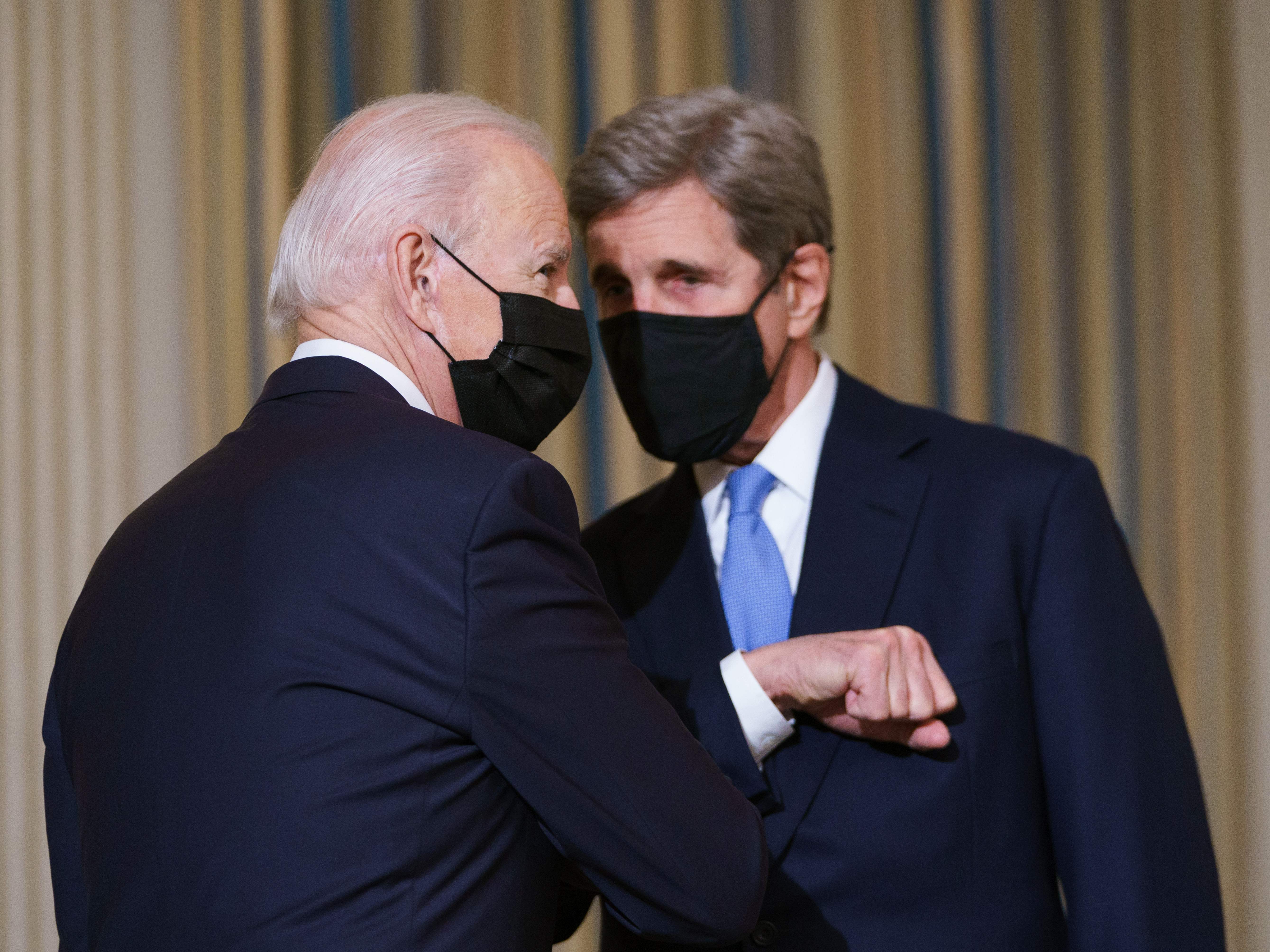 caption: President Biden greets Special Presidential Envoy for Climate John Kerry in January.