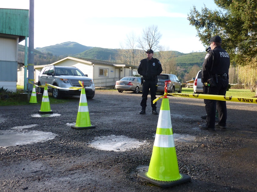 caption: Nooksack tribal police stand outside the courthouse during a disenrollment hearing in 2013.