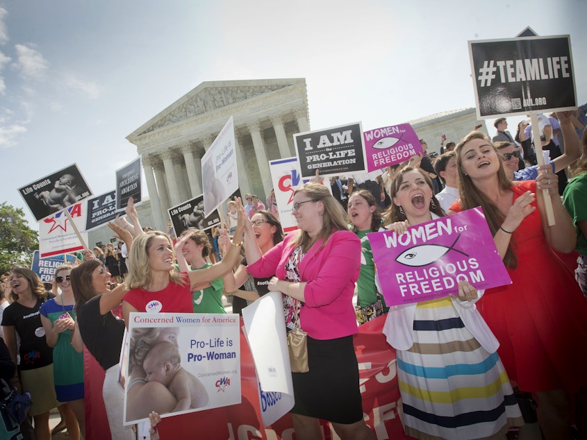 caption: In this 2014 photo, demonstrators react to hearing the Supreme Court's decision on the Hobby Lobby birth control case outside the Supreme Court in Washington. A judge in California has blocked implementation of a Trump administration policy that would let more employers decline to offer birth control coverage on religious or moral grounds.