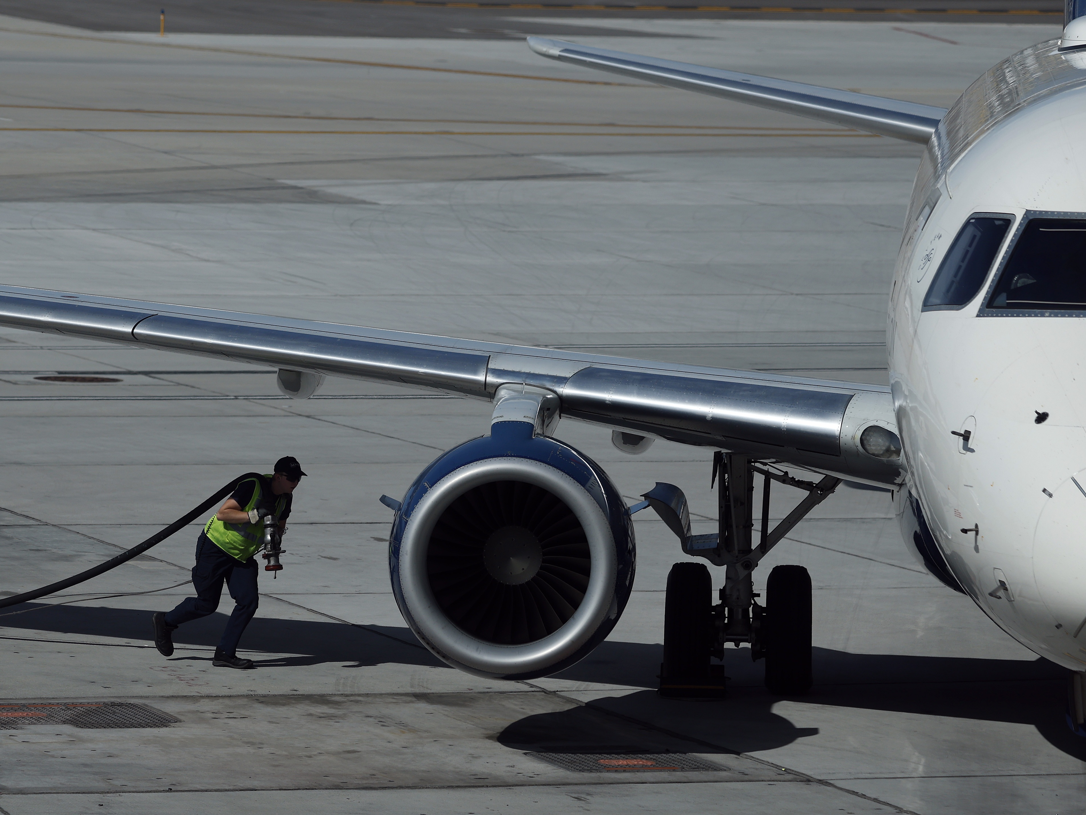caption: A worker fuels a Delta Airlines plane at Salt Lake City International Airport on April 09, 2026. As fuel prices continue to rise amid the war in Iran, airlines around the world are canceling flights and scaling back routes due to surging jet fuel prices.