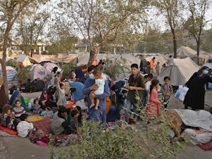 caption: Internally displaced Afghan families, who fled from Kunduz, Takhar and Baghlan province due to battles between Taliban and Afghan security forces, sit in front of their temporary tents at Sara-e-Shamali in Kabul on August 11, 2021.