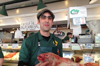 caption: Fishmonger Andrew Wichmann says cruise ship traffic is great for Seattle but doesn't do much for him directly. They can't bring food onboard. "We wouldn't survive without local clientele."