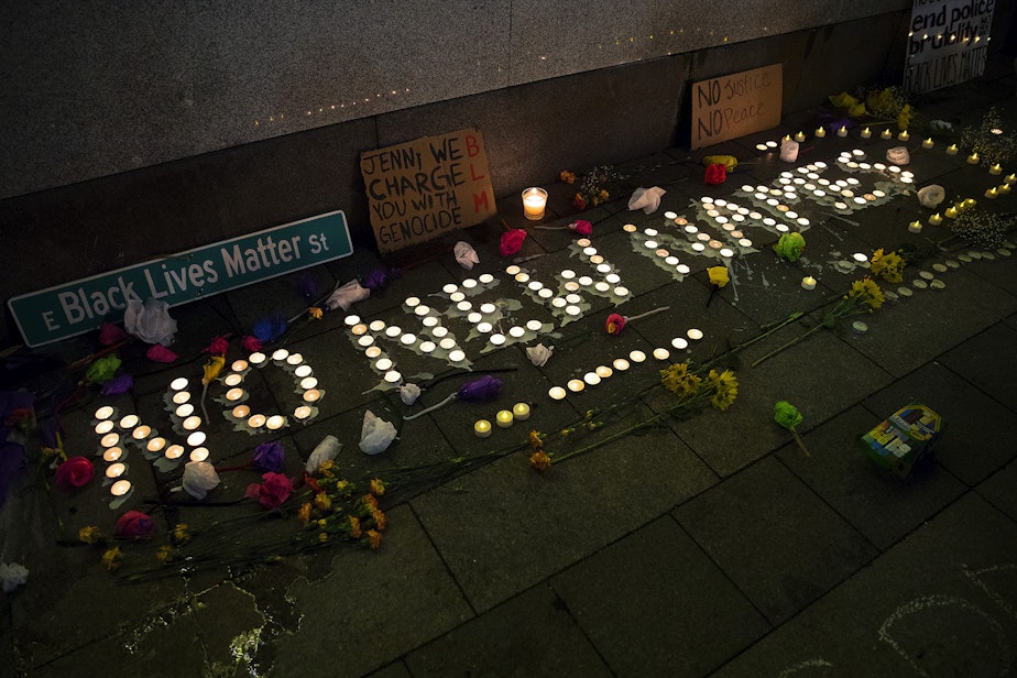 caption: Lit candles spell 'No New Names' during a vigil in honor of a person who was shot and killed by two Seattle Police officers while in a crisis and holding a knife on Tuesday along Seattle's waterfront, on Wednesday, February 17, 2021, at Westlake Park in Seattle. 