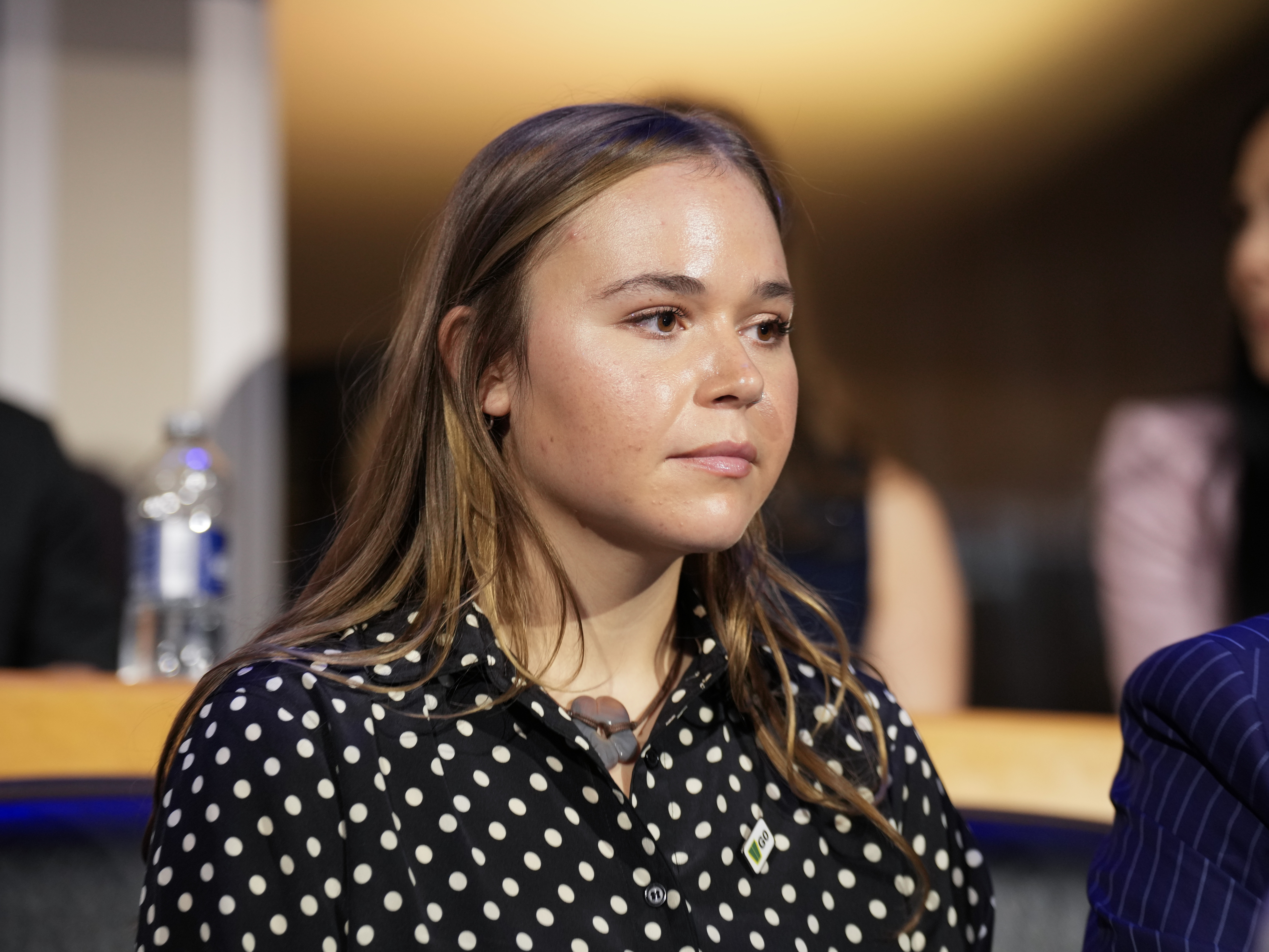 caption: Gov. Tim Walz's daughter, Hope Walz, watches the proceedings during the first day of the Democratic National Convention on Monday in Chicago. 