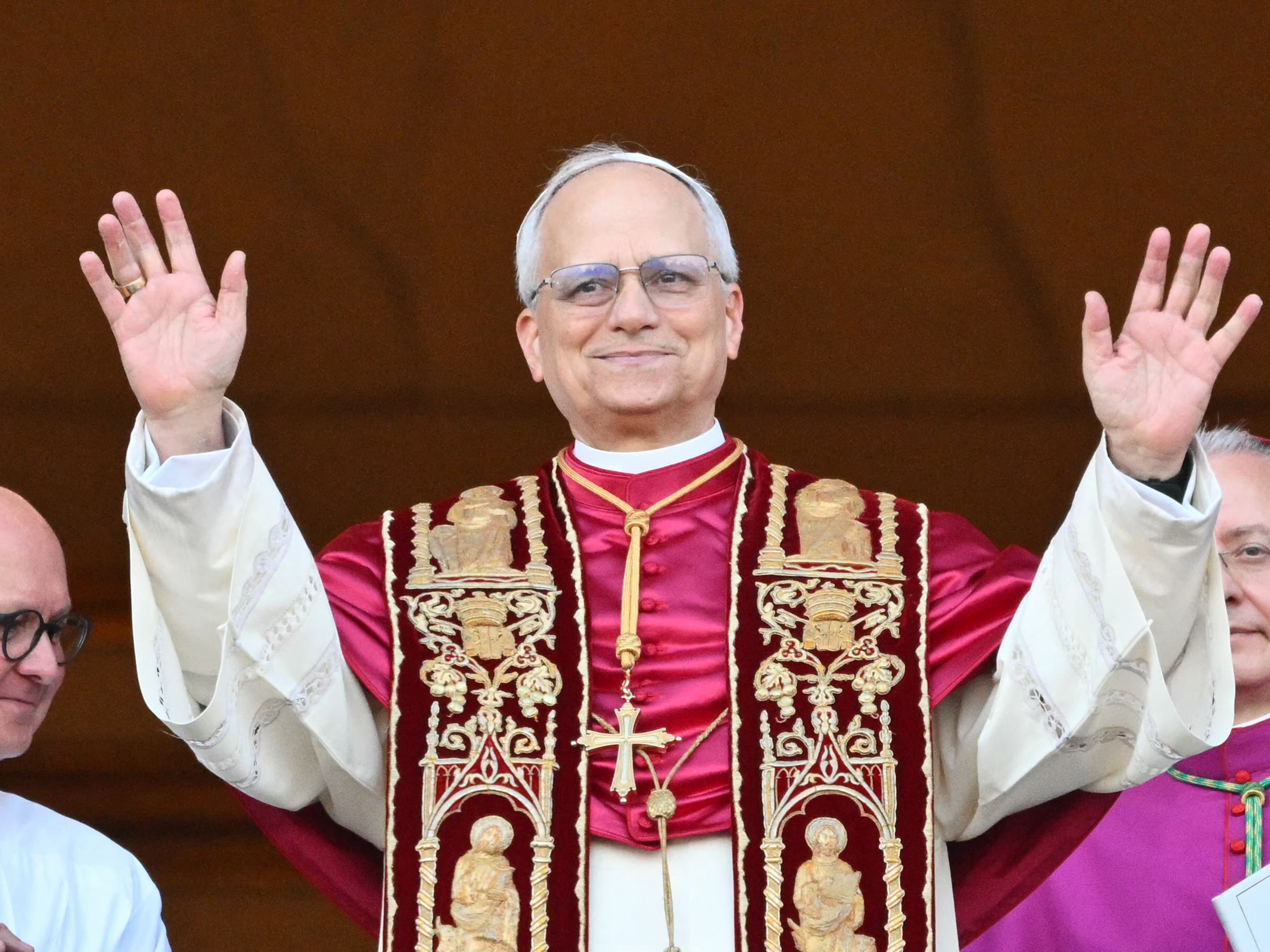 caption: Pope Leo XIV greets the public for the first time from the main balcony of St. Peter's Basilica.