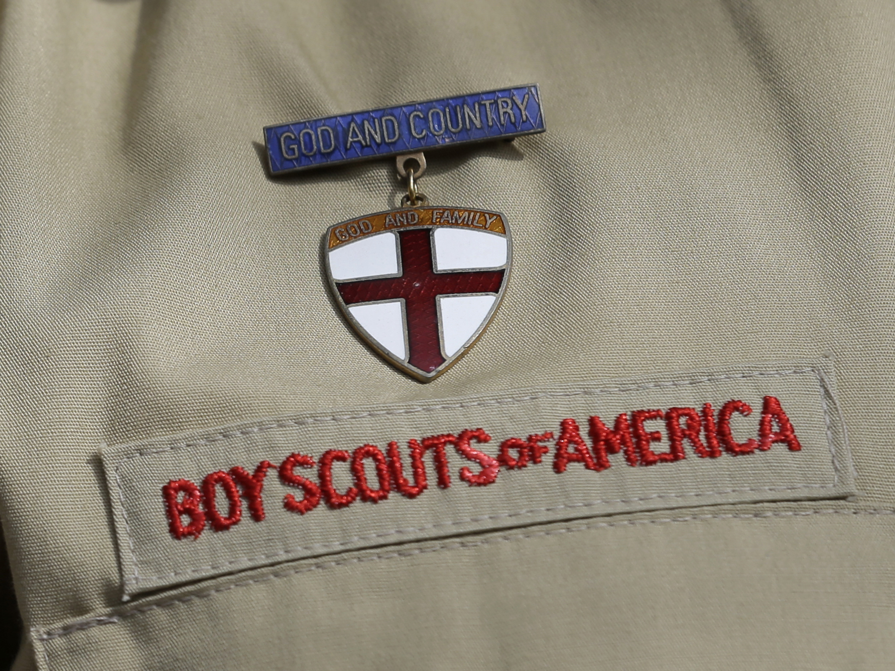 caption: A close up of a Boy Scout uniform is photographed on Feb. 4, 2013, in Irving, Texas. On Tuesday, March 28, 2023, a federal district court judge upheld the approval of a $2.4 billion bankruptcy reorganization plan aimed at resolving tens of thousands of child sexual abuse claim against the Boy Scouts of America.