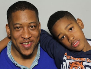 caption: Albert Sykes fielded questions from his son, Aiden, at StoryCorps in Jackson, Miss.