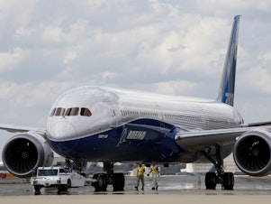 caption: Boeing employees walk the new Boeing 787-10 Dreamliner down towards the delivery ramp area at the company's facility after conducting its first test flight at Charleston International Airport in 2017. A Senate subcommittee has opened an investigation into the safety of Boeing jetliners, intensifying safety concerns about the company's aircraft.