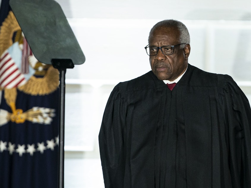 caption: U.S. Supreme Court Justice Clarence Thomas listens during a ceremony on the South Lawn of the White House in Washington, D.C., on Oct. 26, 2020.
