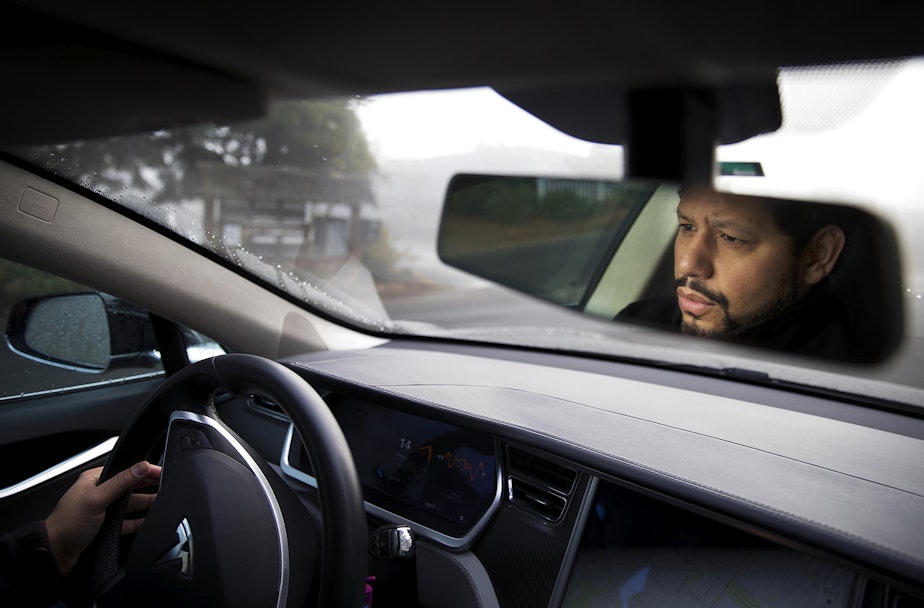 caption: Nesib CB Shamah drives his Model S Tesla on Monday, December 11, 2017, near his home in Seattle.