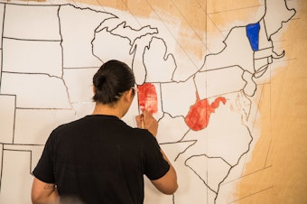 caption: An artist paints a mural, indicating which presidential candidates had won certain states on election night in 2016. Once again, NPR will rely on the Associated Press to provide election results and race calls.