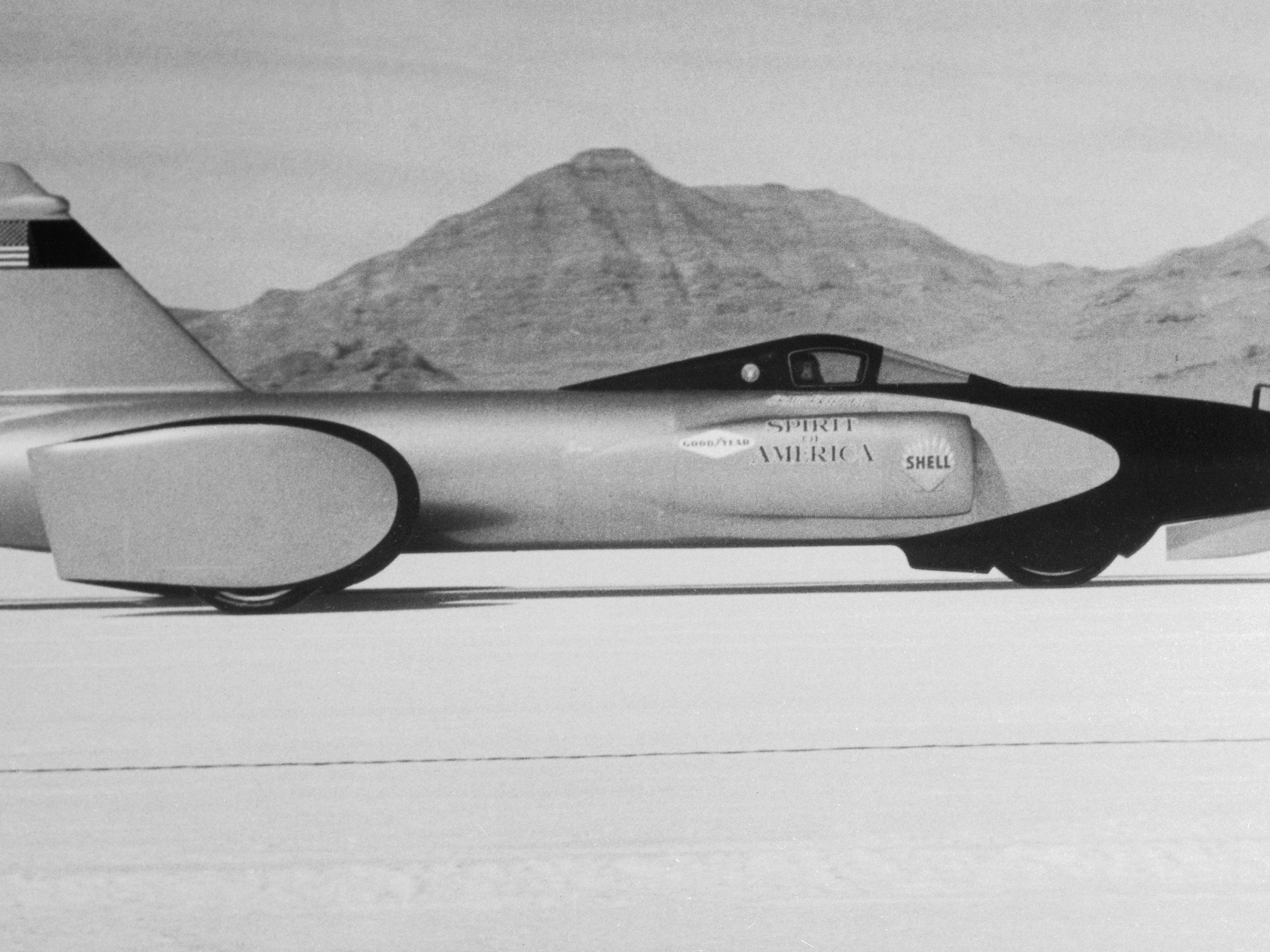 caption: The jet-powered 'Spirit of America,' with Craig Breedlove at the wheel, on the Bonneville Salt Flats. The three-wheeled racer was powered by a J47 engine — the same type used in an F104 jet fighter plane.
