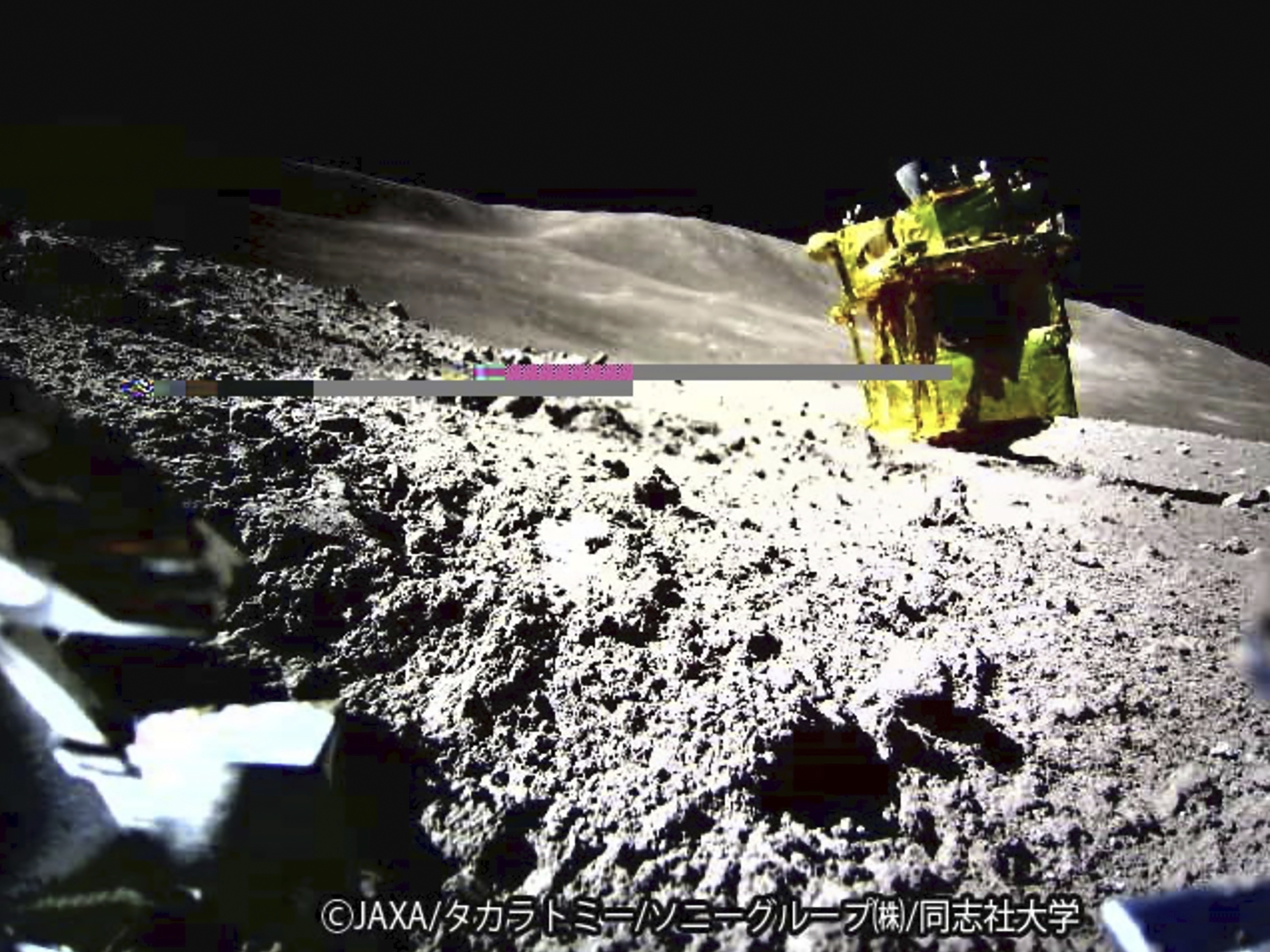 caption: This image provided by the Japan Aerospace Exploration Agency shows an image taken by a Lunar Excursion Vehicle of a robotic moon rover called Smart Lander for Investigating Moon, or SLIM, on the moon.