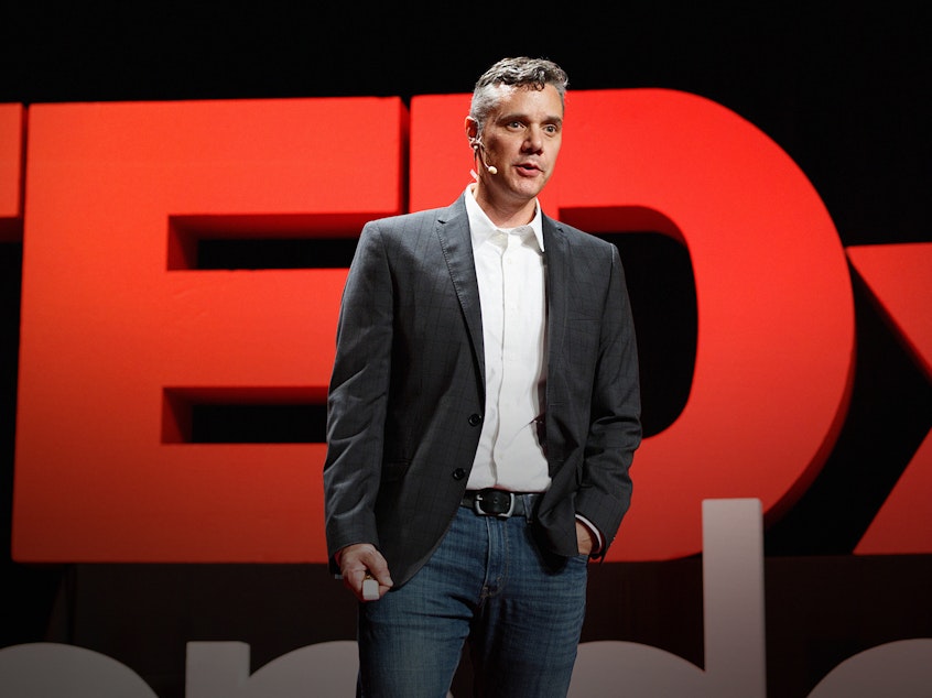 caption: Ryan Martin on the TED stage.