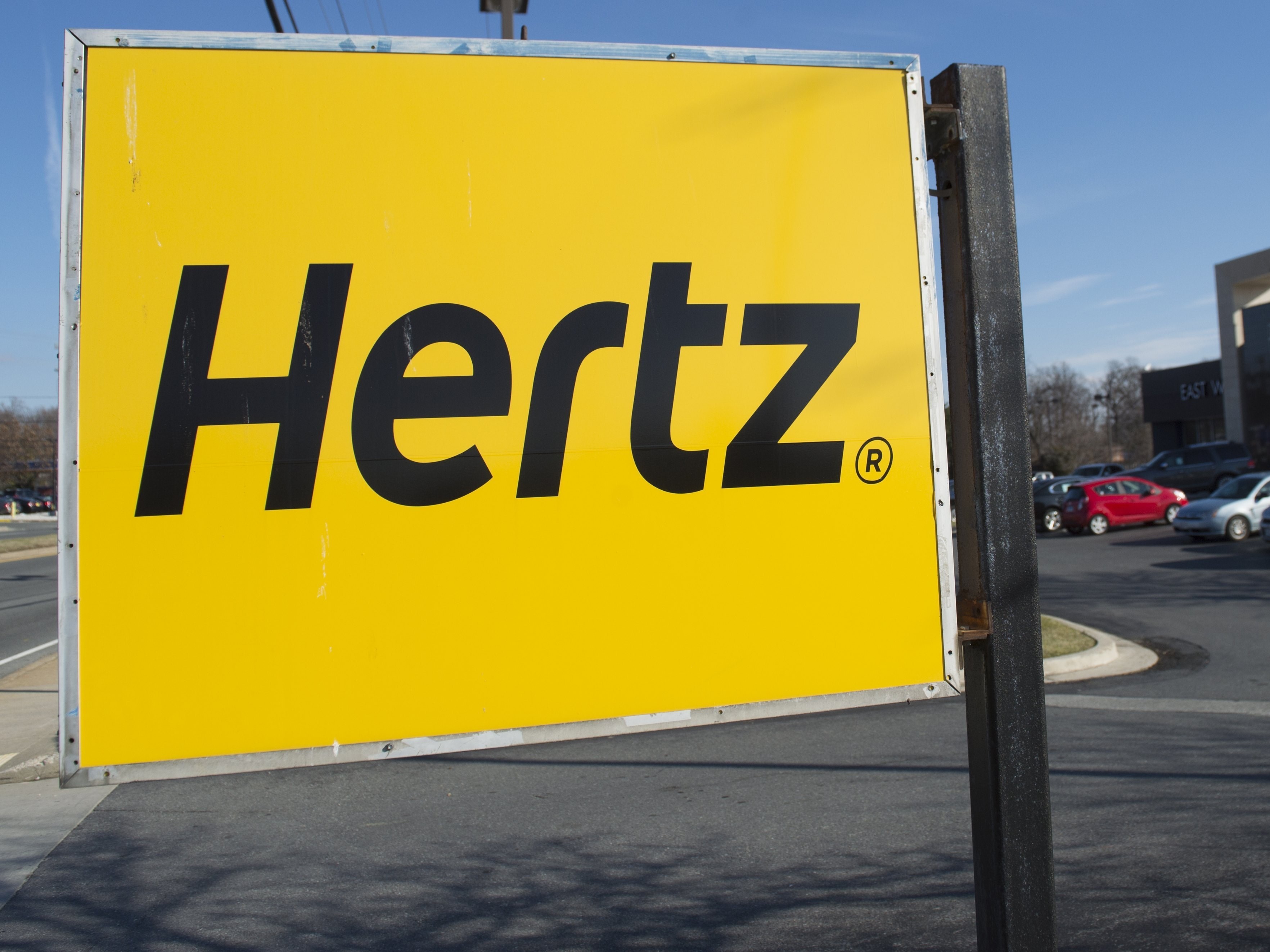 caption: A Hertz car rental logo is seen in Landover Hills, Maryland, December 31, 2014.