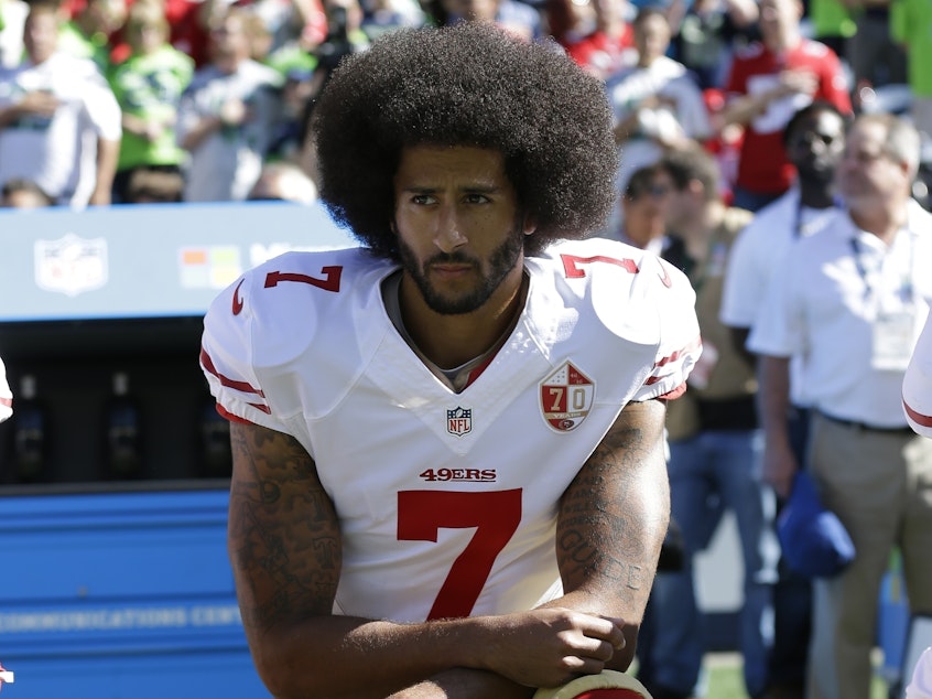 caption: Then-San Francisco 49ers quarterback Colin Kaepernick kneels during the national anthem before a September 2016 game against the Seattle Seahawks in Seattle.
