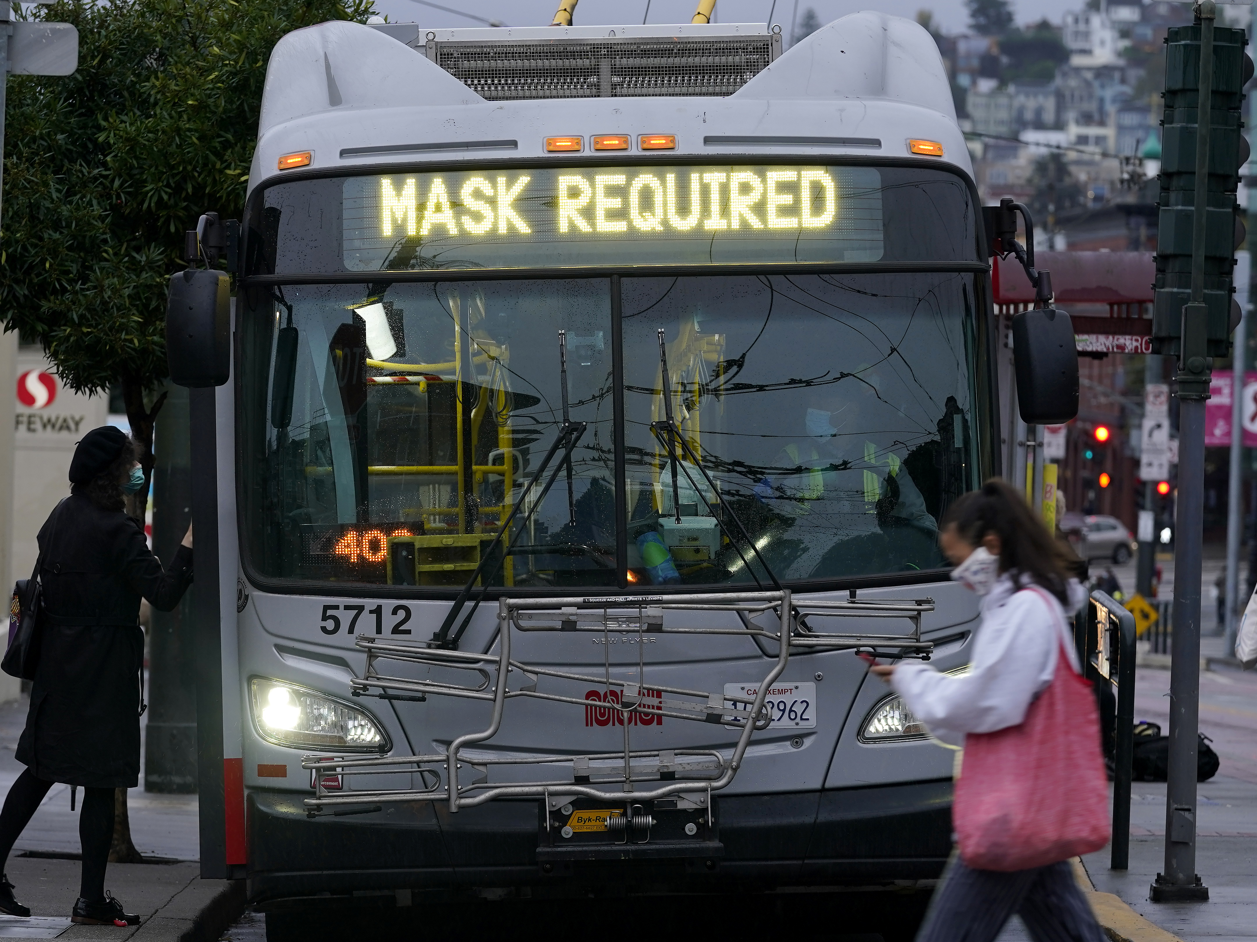 caption: A sign on a San Francisco bus advises that passengers are required to wear masks. Health officials have renewed pleas for Americans to protect themselves and others from the coronavirus as the death toll passes 250,000.