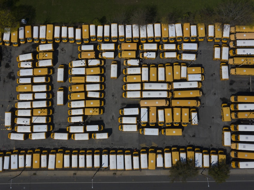 caption: An aerial view of a Freeport, N.Y., school bus parking lot in April 2020.