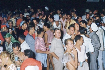caption: People attend a party in Cherry Grove section of Fire Island in New York during the 1960s.
