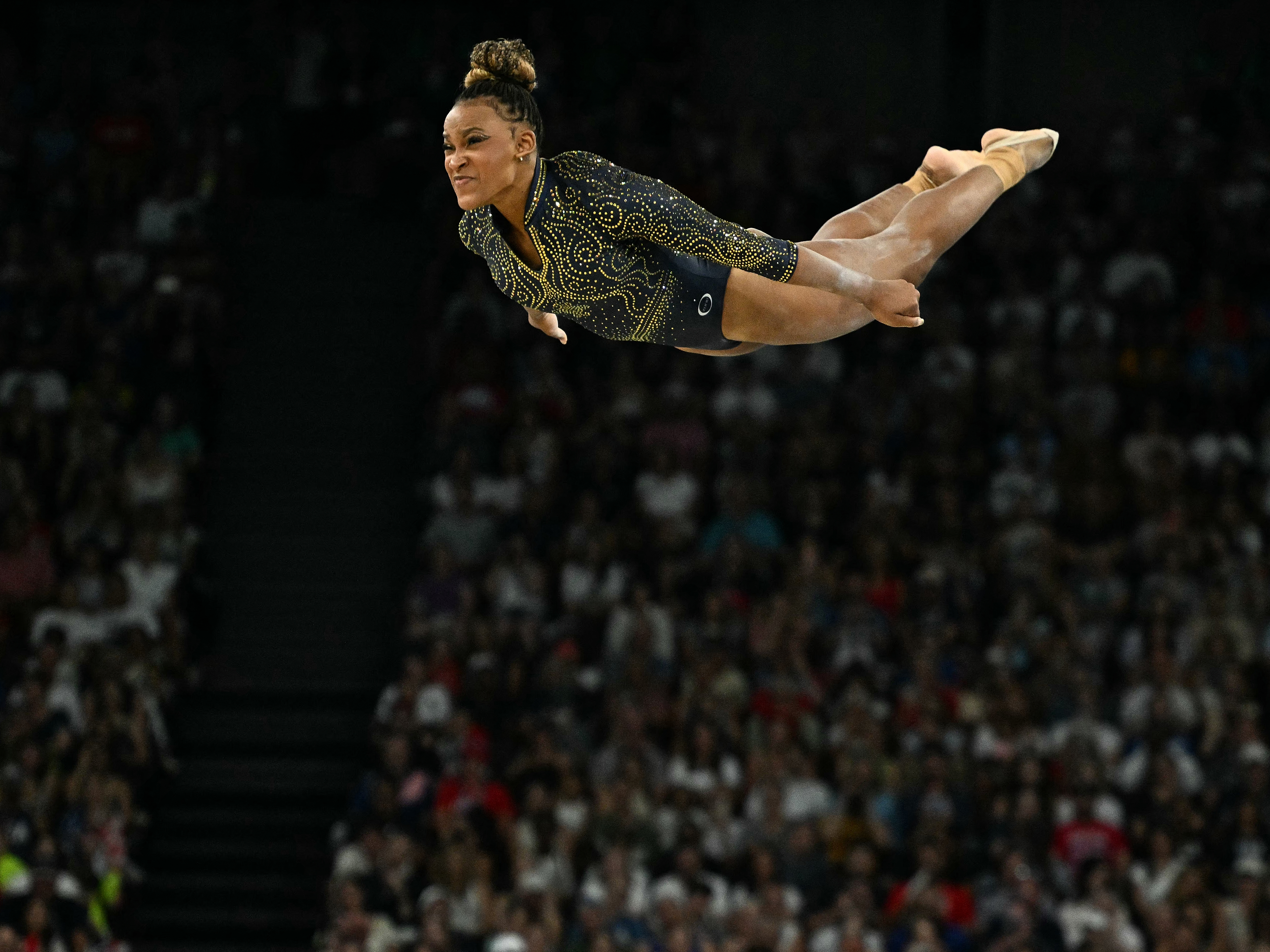 caption: Brazil's Rebeca Andrade competes in the floor exercise event of the artistic gymnastics women's team final during the Paris 2024 Olympic Games at the Bercy Arena in Paris, on July 30.