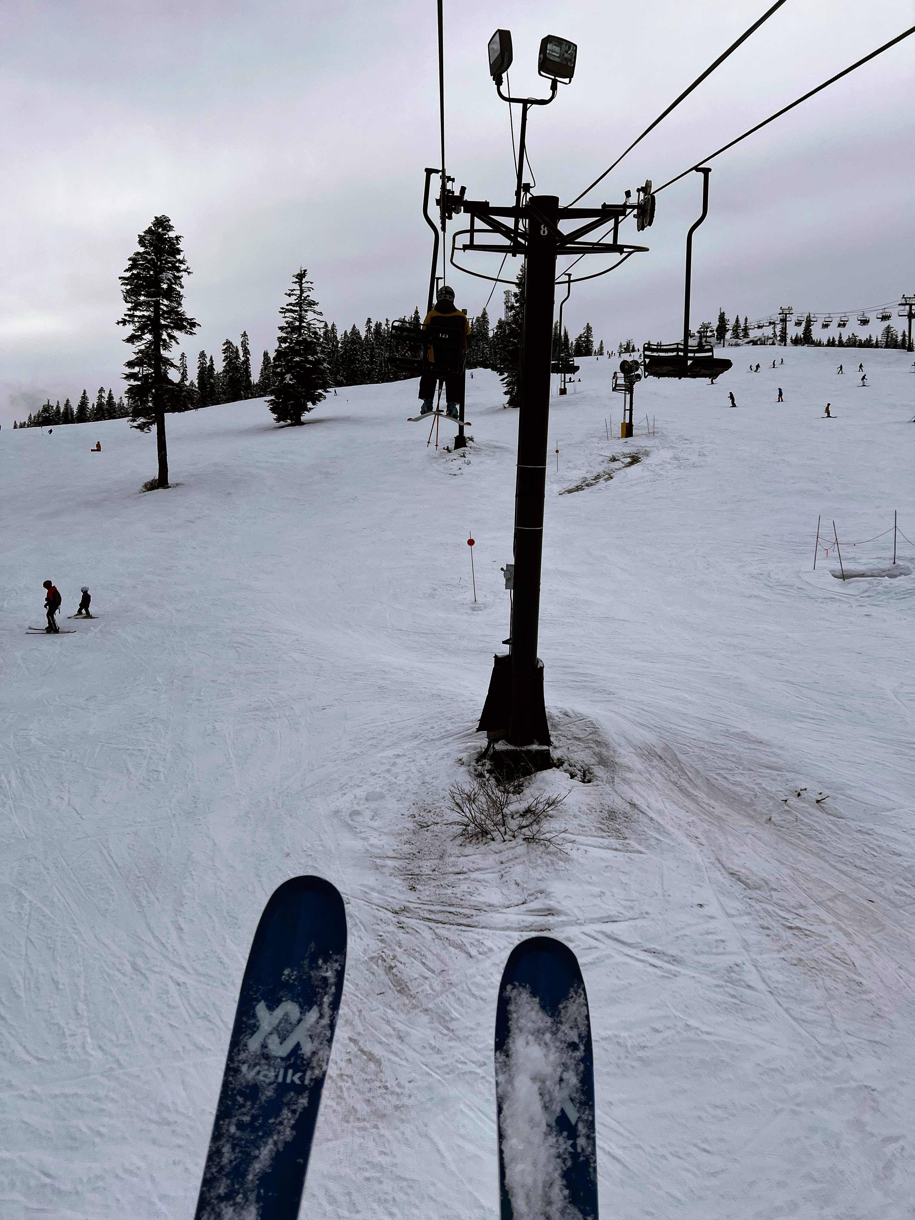 caption: Dirt can be seen through the snow Feb. 16, 2026, on runs that rely on snow-making machines at The Summit at Snoqualmie ski resort in Washington state. 