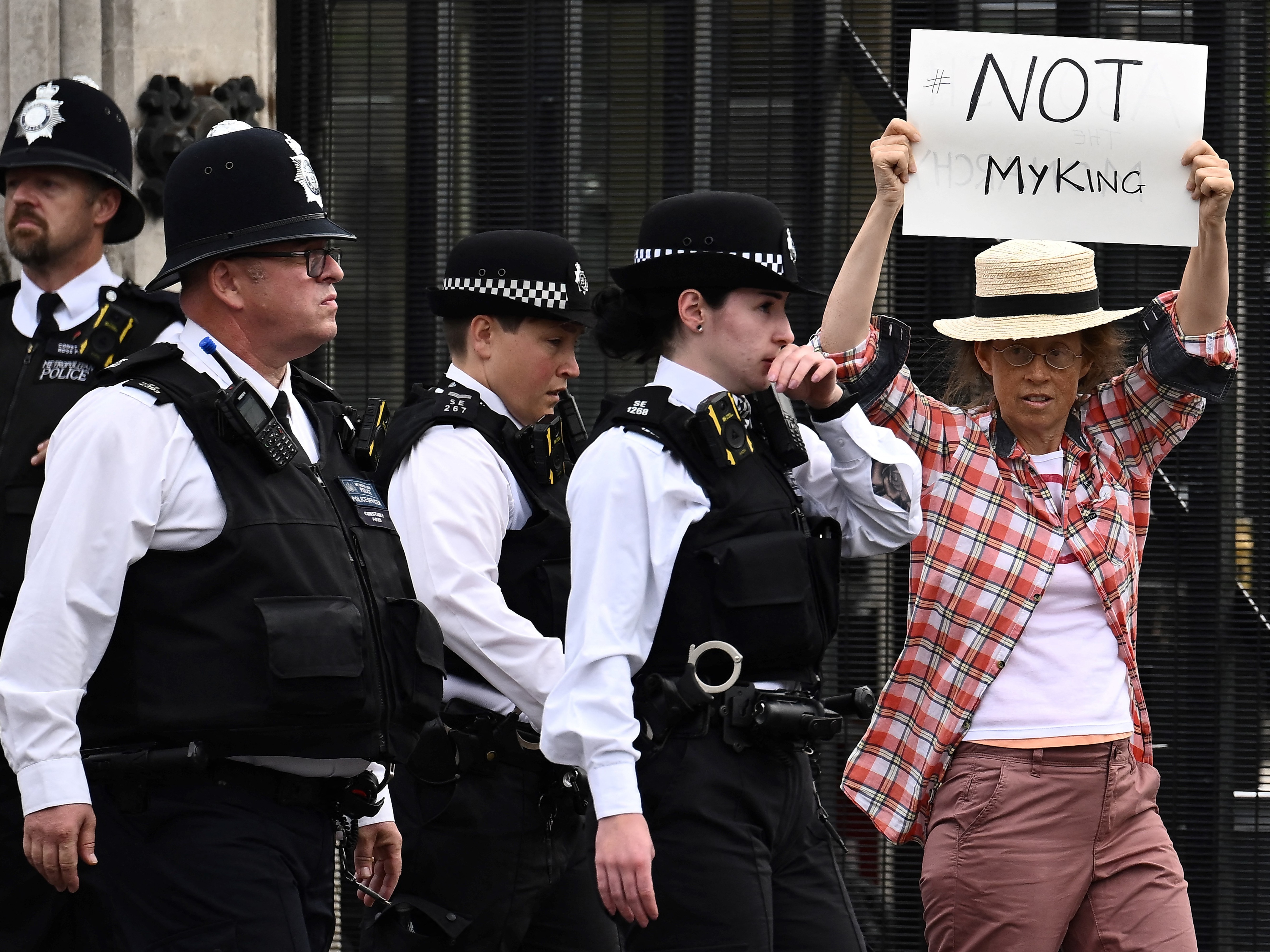 caption: An anti-monarchy demonstrator protests outside Palace of Westminster in central London on Monday. A number of arrests in the U.K. are sparking questions about freedom of speech.